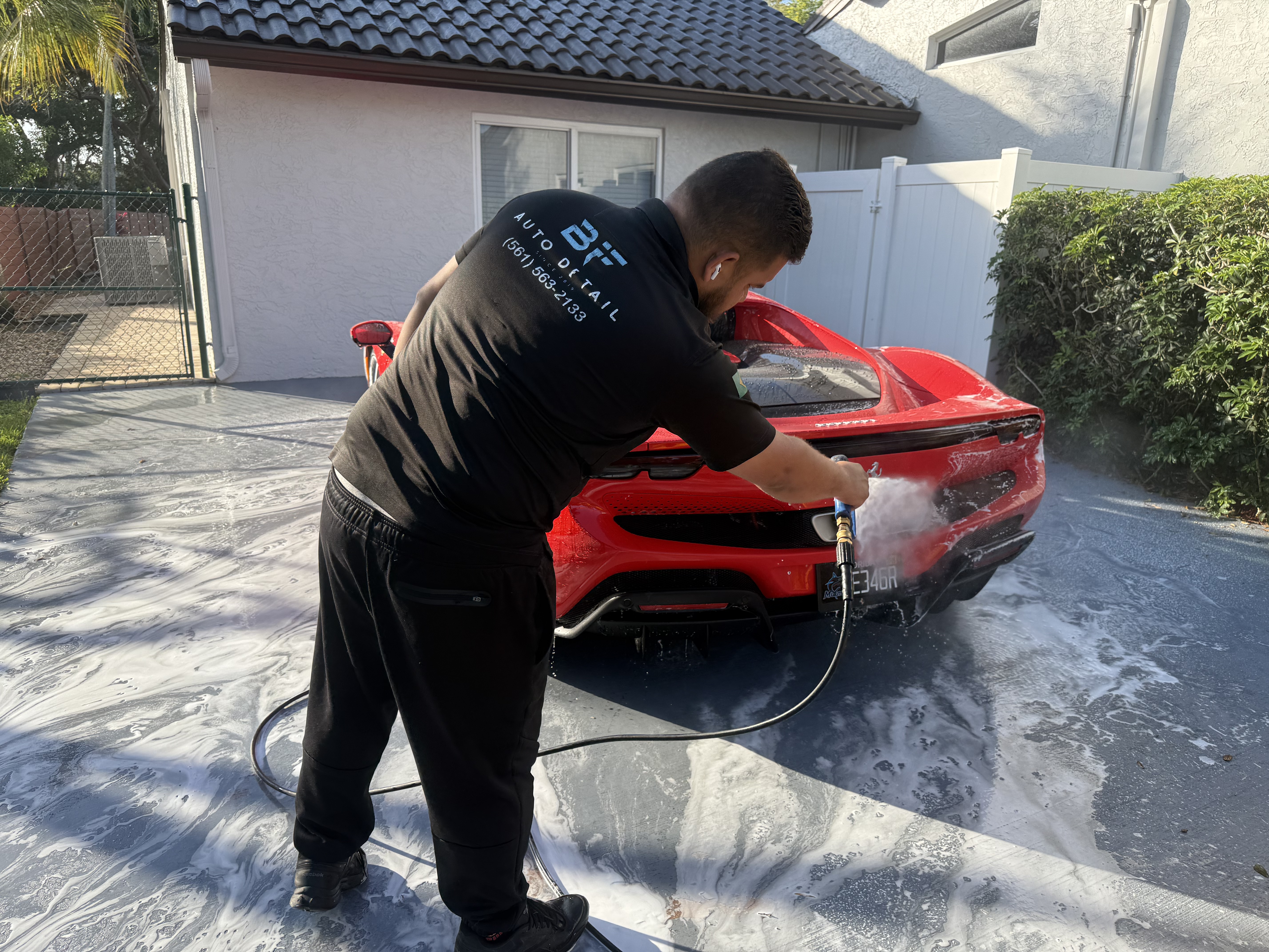 Ferrari being rinsed during a mobile detail