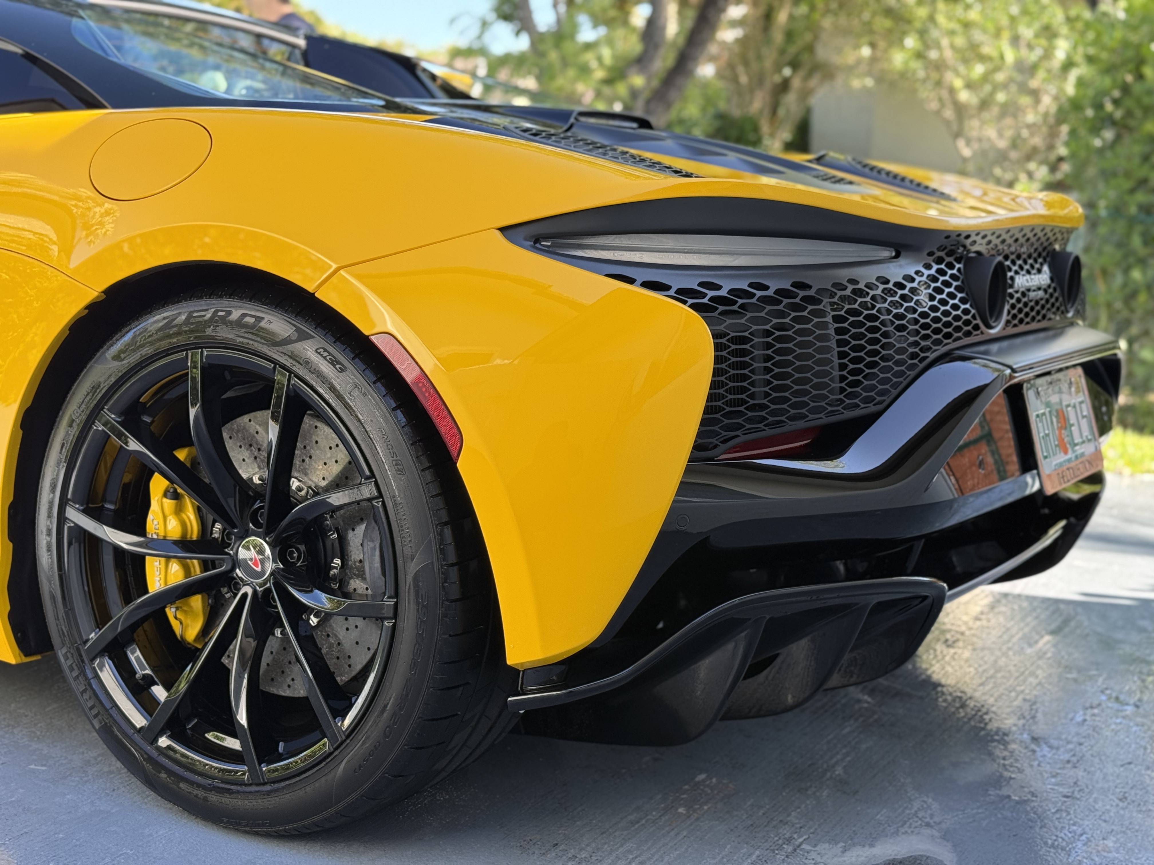 Rear quarter of a yellow McLaren with gloss paint and clean wheels
