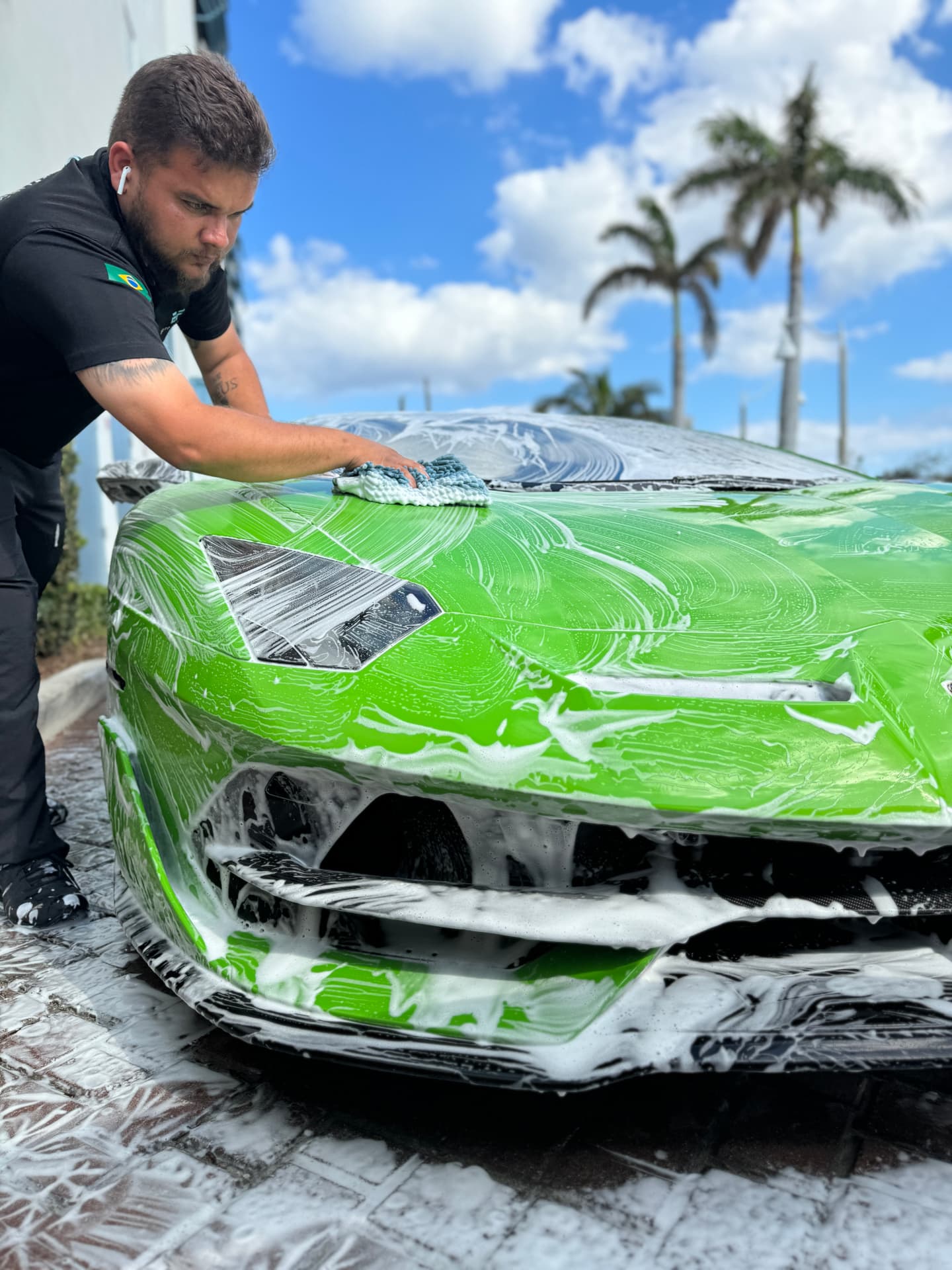 BF Auto Detail technician hand washing a green Lamborghini Aventador